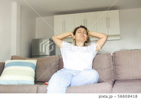 Young woman stretching after waking up Young woman stretching after waking up 56608418