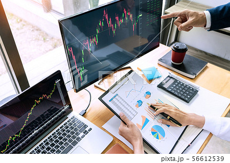 Team of stockbrokers Discussing with display  56612539