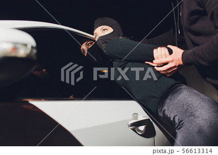 Masked robber woman car robbery found arrest. 56613314