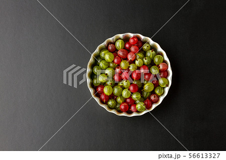 Gooseberries in a metal baking pan on a black Gooseberries in a metal baking pan on a black 56613327