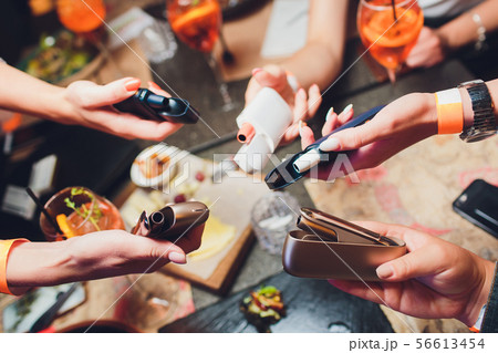 heat-not-burn tobacco product technology. woman holding e-cigarette in his hand before smoking. heat-not-burn tobacco product technology. woman holding e-cigarette in his hand before smoking. 56613454
