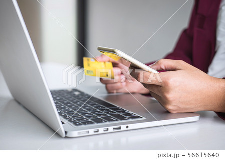 Young woman consumer holding smartphone, credit Young woman consumer holding smartphone, credit 56615640