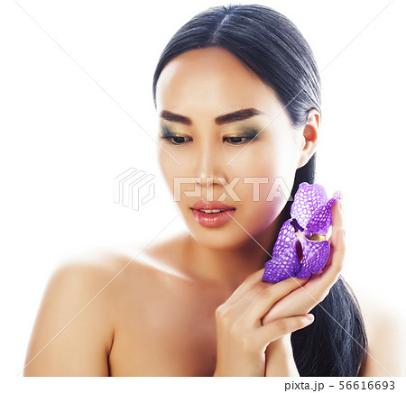 young pretty asian woman with flower purple orchid close up isolated spa, womans day concept young pretty asian woman with flower purple orchid close up isolated spa, womans day concept 56616693