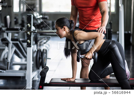 trainer coach dumbbell exercise to woman trainer coach dumbbell exercise to woman 56616944