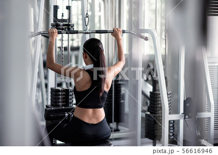 woman exercise with lat pulldown machine in gym 56616946
