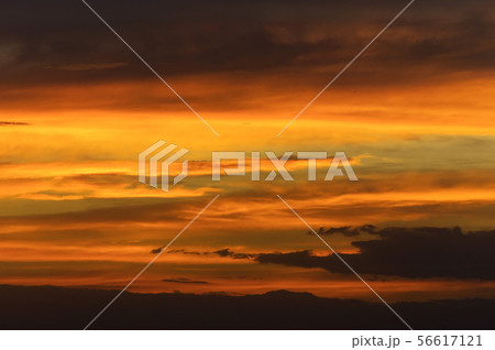 Abstract nature background. Dramatic sunset sky in the clouds saturated with bright colors of orange Abstract nature background. Dramatic sunset sky in the clouds saturated with bright colors of orange 56617121