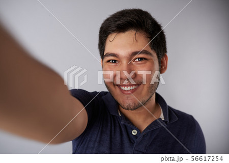 Smiling man taking selfie Smiling man taking selfie 56617254