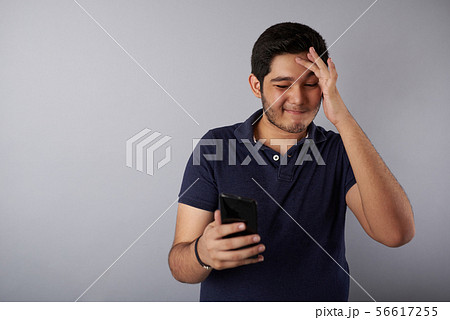 Sad young man with smartphone 56617255