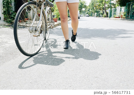 Woman with her bicycle Woman with her bicycle 56617731