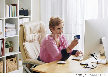 Woman paying for online purchases Woman paying for online purchases 56618167