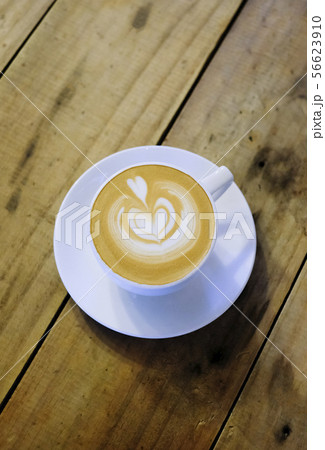 Cups of cafe latte on wooden table background Cups of cafe latte on wooden table background 56623910