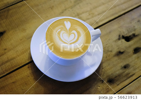 Cups of cafe latte on wooden table background Cups of cafe latte on wooden table background 56623913