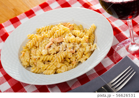 Delicious pasta of smoked salmon at white plate on table Delicious pasta of smoked salmon at white plate on table 56626531