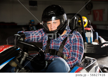 Portrait of happy man driving racing car Portrait of happy man driving racing car 56627416
