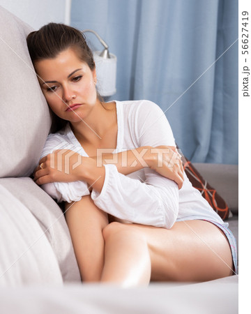 Frustrated woman on sofa 56627419