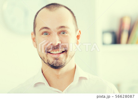 Positive young man in office Positive young man in office 56628087