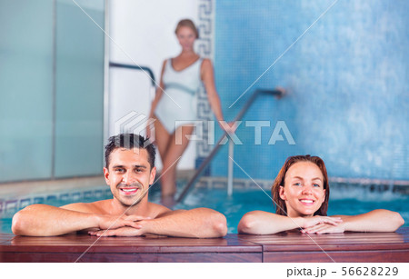 Portrait of couple who is resting in pool in spa salon. Portrait of couple who is resting in pool in spa salon. 56628229