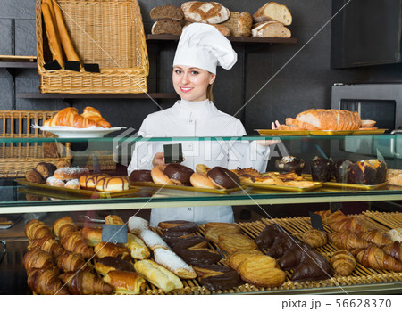Glad female cooks demonstrating and selling to the customer pastry Glad female cooks demonstrating and selling to the customer pastry 56628370