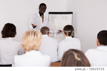 Businessman speaking to physicians Businessman speaking to physicians 56628728