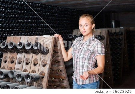 female wine maker in winery cellar. 56628929
