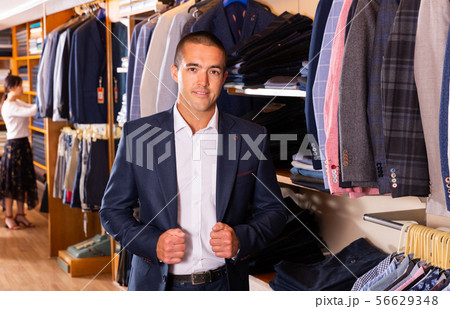 Man trying on new suit in store 56629348