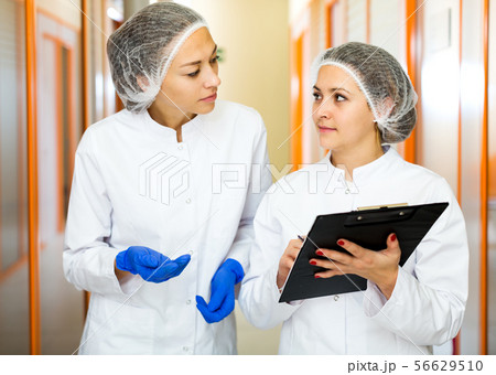 Woman doctors talking about beauty procedures Woman doctors talking about beauty procedures 56629510
