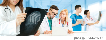 Doctor working in hospital with other doctors. 56629713