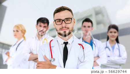 Doctor working in hospital with other doctors. 56629744
