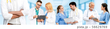 Doctor working in hospital with other doctors. 56629769
