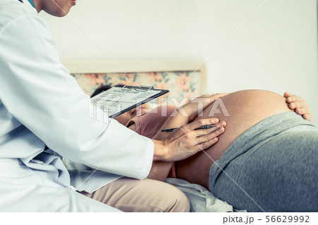 Pregnant Woman and Gynecologist Doctor at Hospital Pregnant Woman and Gynecologist Doctor at Hospital 56629992