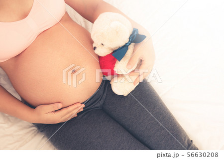 Happy pregnant woman and expecting baby at home. Happy pregnant woman and expecting baby at home. 56630208