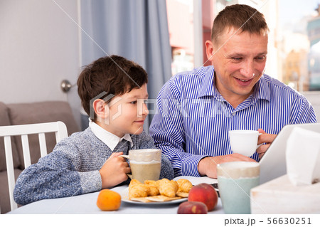 Happy boy with father using laptop 56630251
