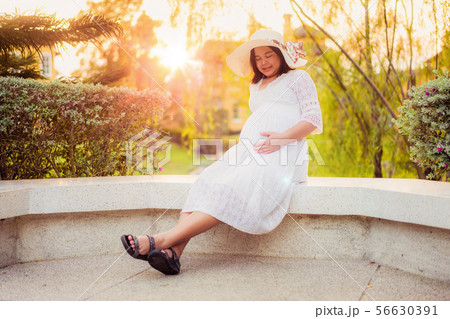 Pregnant woman feeling happy at garden home. Pregnant woman feeling happy at garden home. 56630391