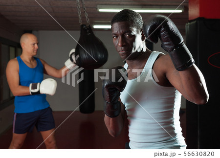 Confident afro american in boxing rack Confident afro american in boxing rack 56630820
