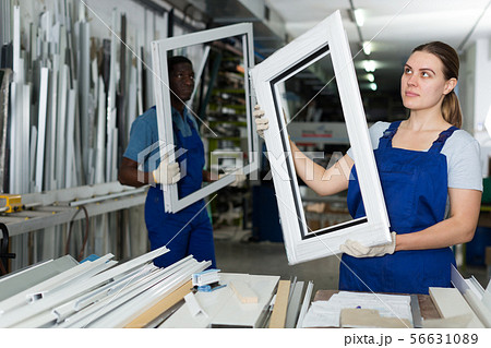 Portrait of woman worker who is standing with window frame 56631089