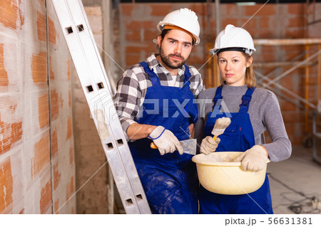 Portrait of two painters inside a cottage under construction 56631381