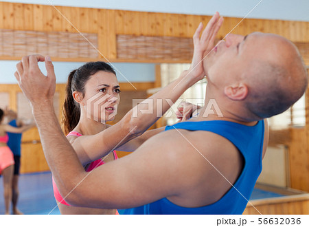 Woman is training with man on the self-defense course in gym 56632036