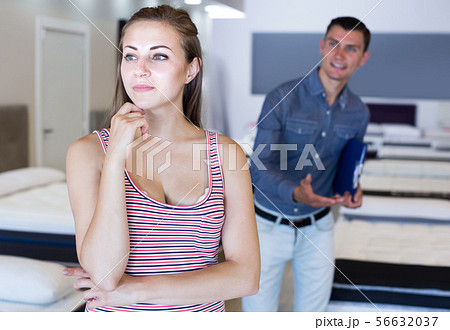 Manager working with female selecting new mattress 56632037
