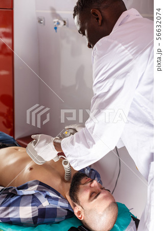 Rescue team making defibrillation to patient Rescue team making defibrillation to patient 56632074