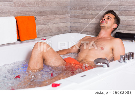 Man is relaxing after active day in jacuzzi 56632083