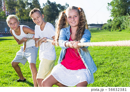 Children pulling rope outdoors Children pulling rope outdoors 56632381