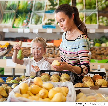 Jolly boy with his mother choosing fruits 56632564