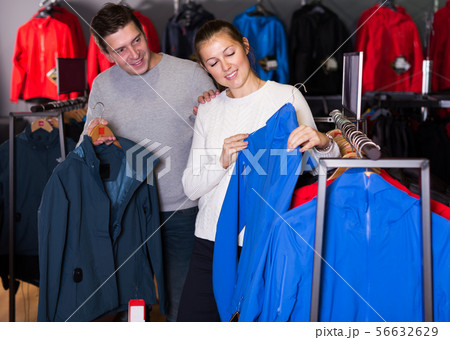 Couple choosing sports clothes Couple choosing sports clothes 56632629