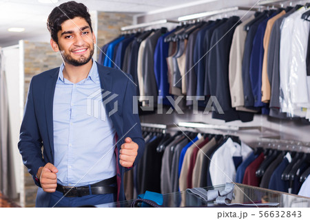 Man is trying on jacket 56632843
