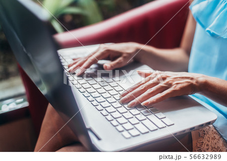 Close-up shot of female hands typing on laptop keyboard 56632989