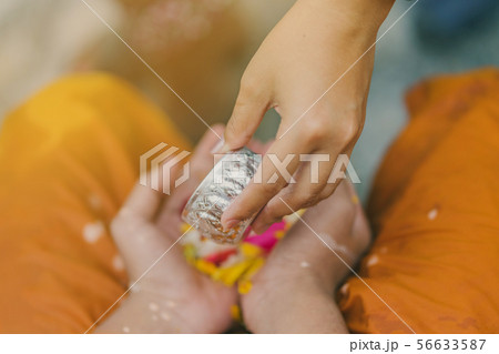 People pouring water to Buddhist Monk  56633587