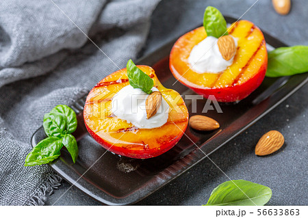 Fried peaches with yogurt, honey and almonds. 56633863