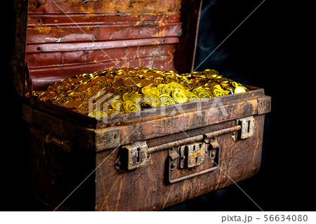 Stacking Gold Coin in treasure chest  on black bac 56634080