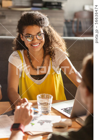 Delighted nice woman smiling to her friend 56636474