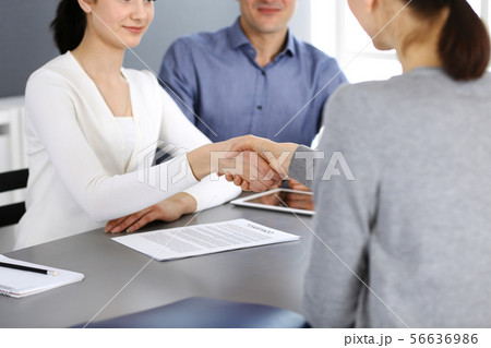 Group of business people shaking hands after discussing questions at meeting in modern office 56636986